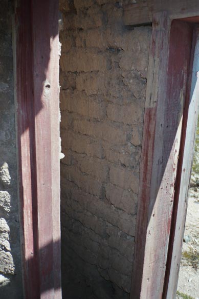 look closley.   There is an inner adobe wall and an outer adobe wall.   This was a building in a building.   The inner building remained cool...perfect for storing dynamite