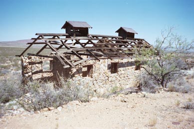 although it looks like a schoolhouse, closer exmaniation reveals cement foundations for equipment and engines.   A mine entrance is within 30 feet.